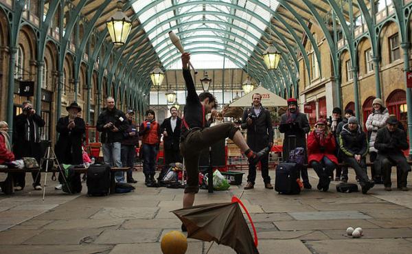 A juggler performs during an audition for a busking spot in the North Hall at Covent Garden Market. A juggler performs during an audition for a busking spot in the North Hall at Covent Garden Market.