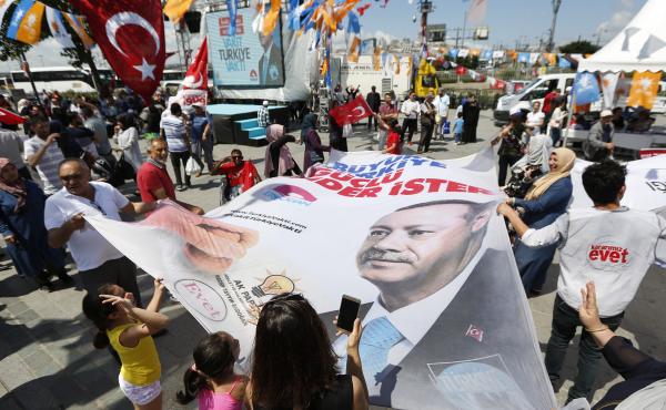 People wave a banner showing Turkey's President Recep Tayyip Erdogan during a gathering of supporters of his ruling Justice and Development Party (AKP) in Istanbul. People wave a banner showing Turkey's President Recep Tayyip Erdogan during a gathering of supporters of his ruling Justice and Development Party (AKP) in Istanbul.