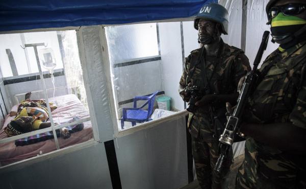 United Nations peacekeepers stand next to a patient during a visit of the U.N. secretary-general at an Ebola treatment center in Mangina, North Kivu province, last September. United Nations peacekeepers stand next to a patient during a visit of the U.N. secretary-general at an Ebola treatment center in Mangina, North Kivu province, last September.