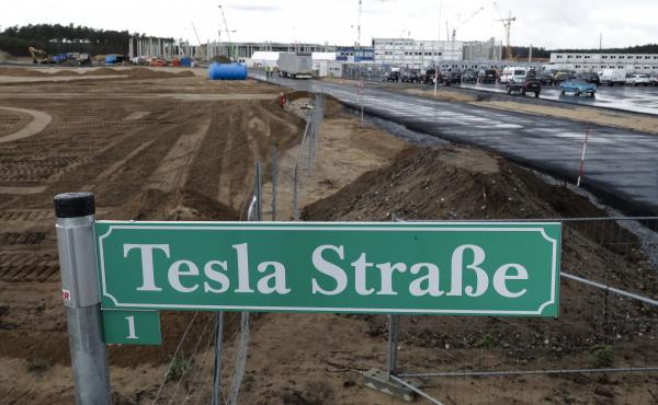 A street sign says "Tesla Street 1" in front of the construction site of the Tesla Gigafactory near Berlin. The electric automaker plans to start building cars this summer at its first European production site. A street sign says "Tesla Street 1" in front of the construction site of the Tesla Gigafactory near Berlin. The electric automaker plans to start building cars this summer at its first European production site.