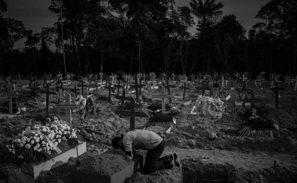 A man cries over his mother's grave in the Nossa Senhora Aparecida cemetery, in Manaus, Amazonas, Brazil, on Sept. 29, 2020. Iris Gonçalves Alves died at age 54 the previous day from COVID-19, according to the information on her burial record. During the A man cries over his mother's grave in the Nossa Senhora Aparecida cemetery, in Manaus, Amazonas, Brazil, on Sept. 29, 2020. Iris Gonçalves Alves died at age 54 the previous day from COVID-19, according to the information on her burial record. During the