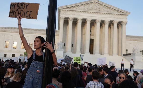A person holds a sign during a rally in front of the Supreme Court on Tuesday in response to its leaked draft decision to overturn Roe v. Wade. A person holds a sign during a rally in front of the Supreme Court on Tuesday in response to its leaked draft decision to overturn Roe v. Wade.