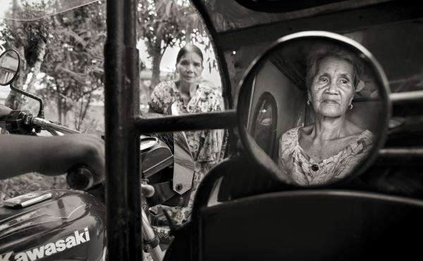 Isabelita Vinuya, 88, reflected in mirror, bids farewell to Perla Bulaon Balingit in the village of Mapaniqui in Pampanga. They are two of the last living "comfort women" of the Philippines. On Nov. 23, 1944, Vinuya, Balingit and some 100 other girls and Isabelita Vinuya, 88, reflected in mirror, bids farewell to Perla Bulaon Balingit in the village of Mapaniqui in Pampanga. They are two of the last living "comfort women" of the Philippines. On Nov. 23, 1944, Vinuya, Balingit and some 100 other girls and