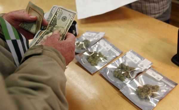 A customer buys marijuana at Harborside dispensary in Oakland, Calif., on Monday. A customer buys marijuana at Harborside dispensary in Oakland, Calif., on Monday.
