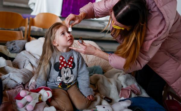 Ukrainian refugee Alina Archipova gives her daughter medication at a temporary shelter in Berlin, Germany, on March 10. Ukrainian refugee Alina Archipova gives her daughter medication at a temporary shelter in Berlin, Germany, on March 10.