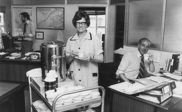 A tea lady brings round refreshments for British office workers in the 1970s. All over the U.K., the arrival of the tea ladies with trolleys loaded with a steaming tea urn and a tray of cakes or buns was the high point of the workday. A tea lady brings round refreshments for British office workers in the 1970s. All over the U.K., the arrival of the tea ladies with trolleys loaded with a steaming tea urn and a tray of cakes or buns was the high point of the workday.