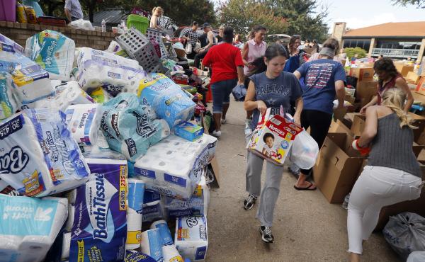 Volunteers organize stacks of donations that were dropped off Tuesday at the North Dallas location for Hurricane Harvey victims. Volunteers organize stacks of donations that were dropped off Tuesday at the North Dallas location for Hurricane Harvey victims.