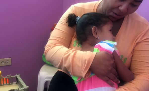 Susette, age 4, with her mother, Carmen. The child's father left Venezuela for Chile to earn money to send back home. Susette, age 4, with her mother, Carmen. The child's father left Venezuela for Chile to earn money to send back home.
