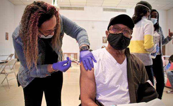 Thomas W. Munson receives his second dose of COVID-19 vaccination from registered nurse Elizabeth Lash at a Sayre Health clinic held at Tablenacle Lutheran Church in West Philadelphia. Thomas W. Munson receives his second dose of COVID-19 vaccination from registered nurse Elizabeth Lash at a Sayre Health clinic held at Tablenacle Lutheran Church in West Philadelphia.