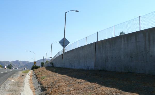 The proposed overpass would allow mountain lions to cross this section of freeway. One mountain lion was hit near here after apparently failing to make it over this wall. The proposed overpass would allow mountain lions to cross this section of freeway. One mountain lion was hit near here after apparently failing to make it over this wall.