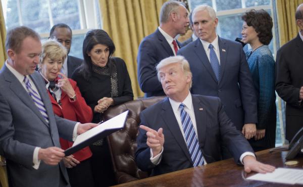 President Donald Trump looks over towards Budget Director Mick Mulvaney, left, after signing his "Comprehensive Plan for Reorganizing the Executive Branch" executive order. President Donald Trump looks over towards Budget Director Mick Mulvaney, left, after signing his "Comprehensive Plan for Reorganizing the Executive Branch" executive order.