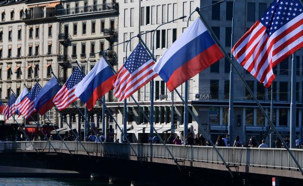 U.S. and Russian flags fly on the Mont-Blanc bridge on the eve of a US-Russia summit on Tuesday in Geneva. A former intelligence operative says agencies are in high gear. U.S. and Russian flags fly on the Mont-Blanc bridge on the eve of a US-Russia summit on Tuesday in Geneva. A former intelligence operative says agencies are in high gear.