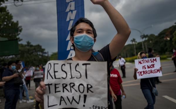 A protester wearing a face mask demonstrates against the Philippines' new anti-terrorism law on July 4, in Quezon city, Metro Manila. Earlier this month, President Rodrigo Duterte approved a law that critics say could lead to more human rights abuses. A protester wearing a face mask demonstrates against the Philippines' new anti-terrorism law on July 4, in Quezon city, Metro Manila. Earlier this month, President Rodrigo Duterte approved a law that critics say could lead to more human rights abuses.