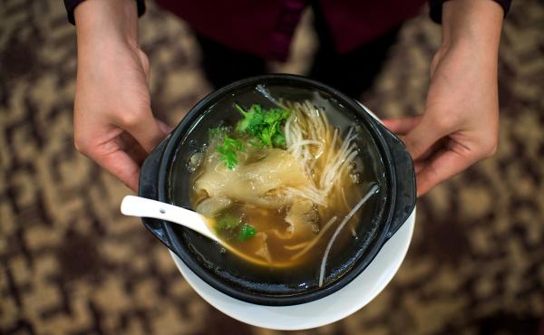 A waitress serves shark fin soup in a restaurant in Guangzhou, in southern China's Guangdong province on Aug. 10, 2014. A waitress serves shark fin soup in a restaurant in Guangzhou, in southern China's Guangdong province on Aug. 10, 2014.