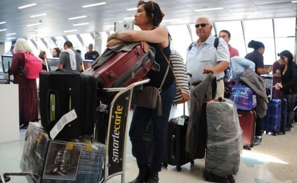 People crowd Fort Lauderdale International Airport as evacuation is underway on Thursday. People crowd Fort Lauderdale International Airport as evacuation is underway on Thursday.