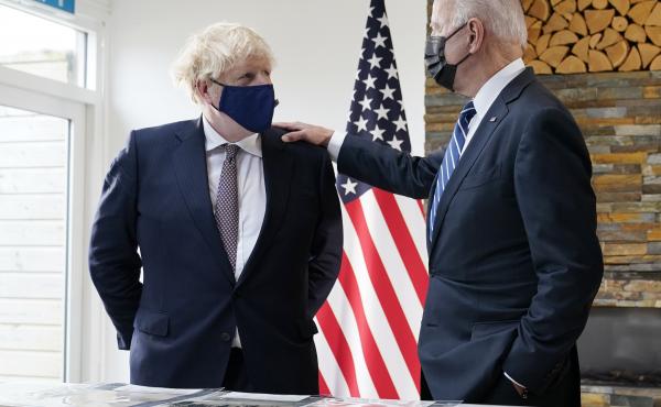 British Prime Minister Boris Johnson and President Biden talk Thursday during a meeting in Carbis Bay, England, as they look over copies of the original Atlantic Charter from 1941. British Prime Minister Boris Johnson and President Biden talk Thursday during a meeting in Carbis Bay, England, as they look over copies of the original Atlantic Charter from 1941.