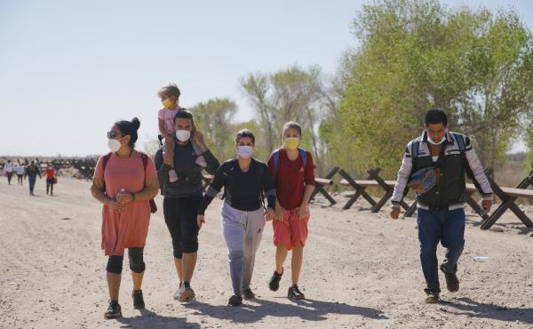 Asylum-seeking migrants from Colombia, Cuba and Venezuela arrive on U.S. soil, after crossing the Colorado River, from Mexico on Feb. 21, in Yuma, Arizona. Asylum-seeking migrants from Colombia, Cuba and Venezuela arrive on U.S. soil, after crossing the Colorado River, from Mexico on Feb. 21, in Yuma, Arizona.