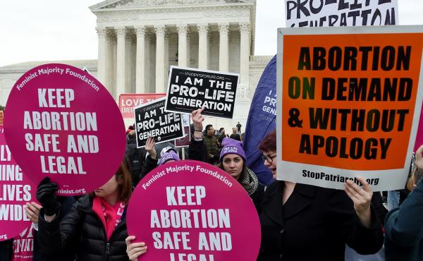 Activists on opposite sides of the abortion debate demonstrate in front of the Supreme Court during the annual anti-abortion-rights event known as the March for Life, on Jan. 24 in Washington, D.C. Activists on opposite sides of the abortion debate demonstrate in front of the Supreme Court during the annual anti-abortion-rights event known as the March for Life, on Jan. 24 in Washington, D.C.