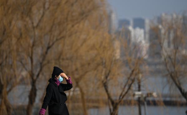 A woman walks in a park along Yangtze River in Wuhan on Jan. 19, 2021. Residents of the city of 11 million, which was the first epicenter of COVID-19, have conflicting emotions as they reckon with the aftermath of the virus and their 76-day lockdown. A woman walks in a park along Yangtze River in Wuhan on Jan. 19, 2021. Residents of the city of 11 million, which was the first epicenter of COVID-19, have conflicting emotions as they reckon with the aftermath of the virus and their 76-day lockdown.