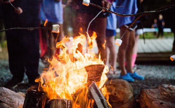Cooking s'mores around a campfire. Cooking s'mores around a campfire.