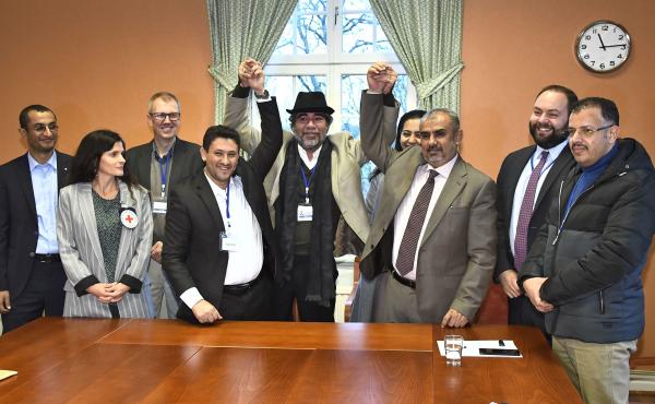 Representatives of the Houthi rebel delegation (left) and the Yemeni government's delegation (right) pose for a picture with representatives from the office of the U.N. Special Envoy for Yemen and the International Committee of the Red Cross on Tuesday, d Representatives of the Houthi rebel delegation (left) and the Yemeni government's delegation (right) pose for a picture with representatives from the office of the U.N. Special Envoy for Yemen and the International Committee of the Red Cross on Tuesday, d
