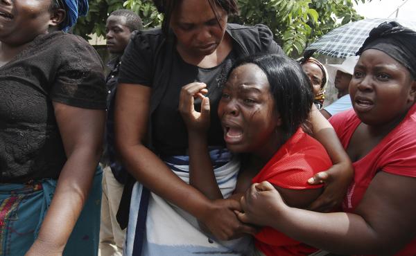 A family member of Kelvin Tinashe Choto reacts, during his funeral in Chitungwiza, about 30 kilometres south east of the capital, Harare, Zimbabwe on Saturday. The 22-year-old was shot in the head, one of at least a dozen people killed in a violent crackd A family member of Kelvin Tinashe Choto reacts, during his funeral in Chitungwiza, about 30 kilometres south east of the capital, Harare, Zimbabwe on Saturday. The 22-year-old was shot in the head, one of at least a dozen people killed in a violent crackd