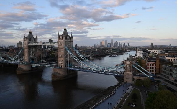 Tower Bridge over The River Thames and, in the distance, the secondary central business district of Canary Wharf are pictured as the sun sets in London. Tower Bridge over The River Thames and, in the distance, the secondary central business district of Canary Wharf are pictured as the sun sets in London.
