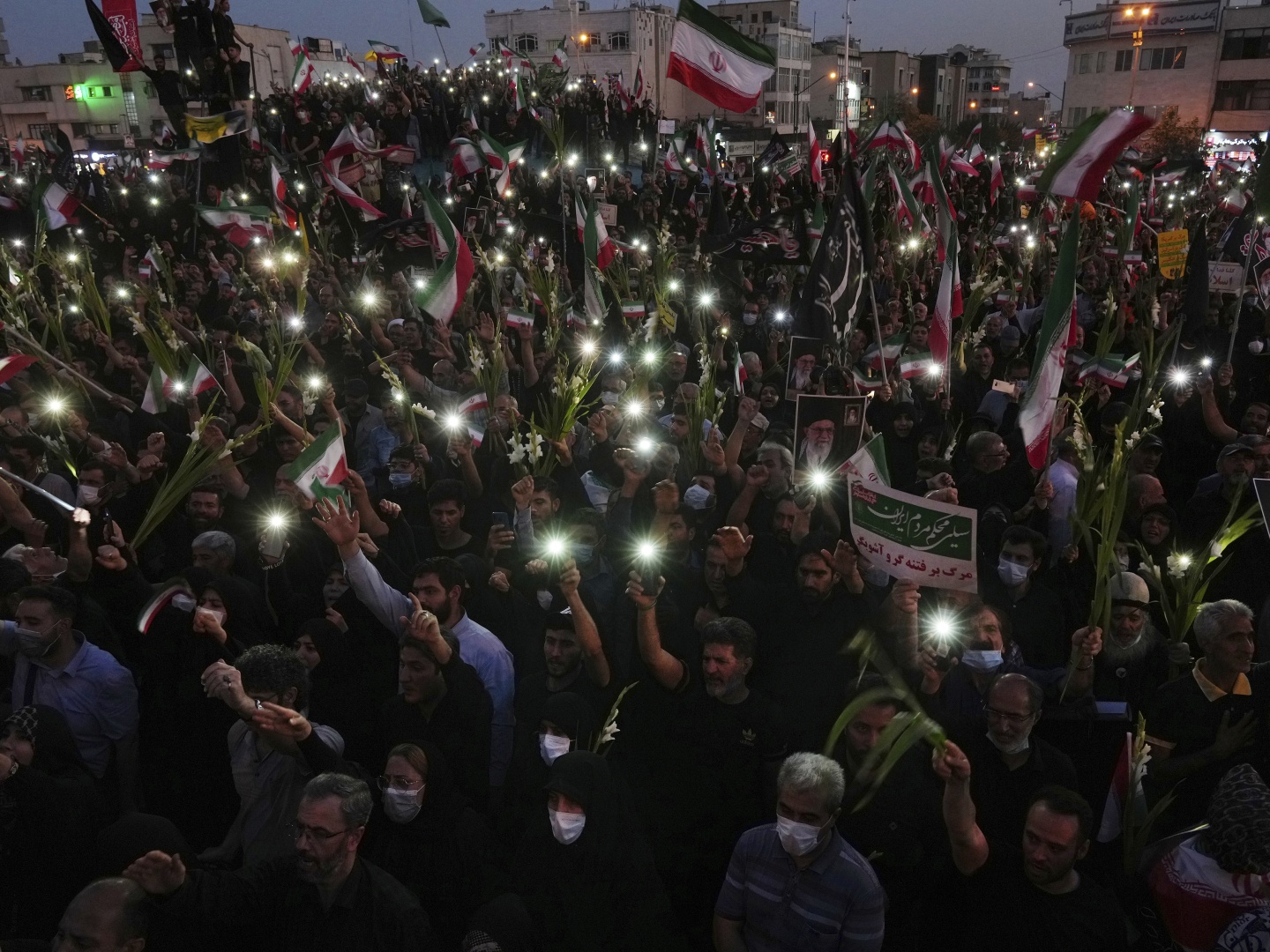 Pro-government demonstrators attend a rally condemning recent anti-government protests over the death of Mahsa Amini, a 22-year-old woman who had been detained by the nation's morality police in Tehran earlier this month.