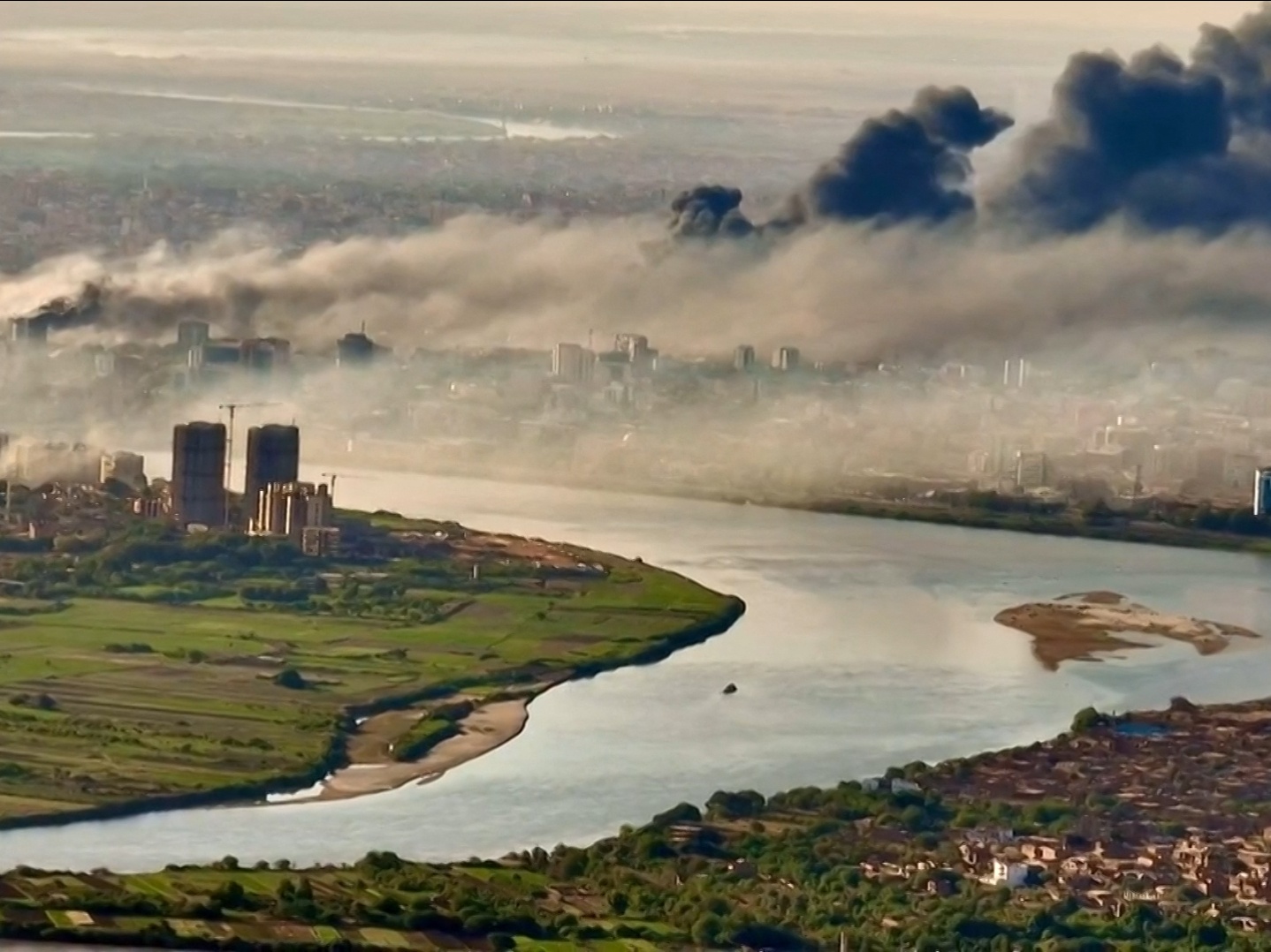 This video grab taken from AFPTV video footage on April 19, 2023, shows an aerial view of black smoke covering the sky above the capital Khartoum.